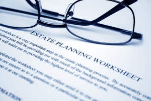 An estate planning worksheet and glasses.