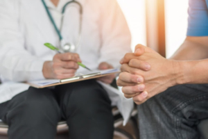 Male patient having consultation with doctor about mental health.